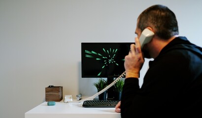 Black Hat Hacker Concept Compromising Green Terminal Mainframe Style Server with 80s and 90s Style Wormhold Animations