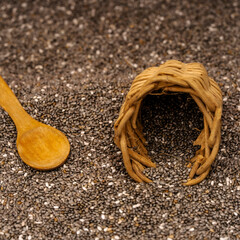 Chia seeds in a wooden bowl with a wooden spoon