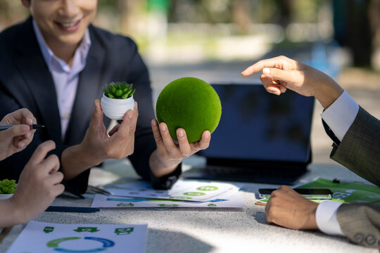 Business people discussing sustainable green environmental strategy - Powered by Adobe