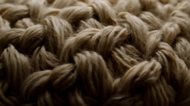 Close look at woven textile from a crafting session showing intricate patterns and textures in a workshop setting