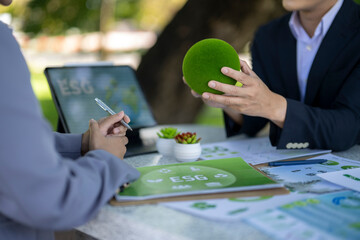 People discussing esg strategy with green earth model