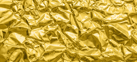 Luxury shiny metallic golden foil crumpled texture background