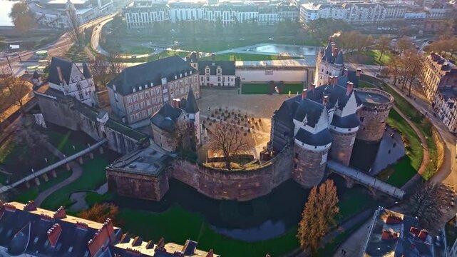 Drone pulls back above the Ch&acirc;teau des ducs de Bretagne revealing courtyard and moats. Nantes