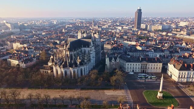 Aerial pull back revealing Nantes Cathedral Saint Pierre and Saint Paul, Place Mar&eacute;chal Foch and cityscape. Tour de Bretagne in Background