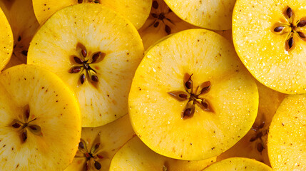 Sliced yellow apples arranged closely, revealing seeds and fresh texture, ideal for food backgrounds and nutrition concepts.