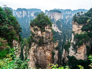 Naklejka premium Majestic sandstone pillars of Zhangjiajie National Forest Park, famously known as the Avatar Mountains. This breathtaking landscape inspired the floating mountains in the famous movie.