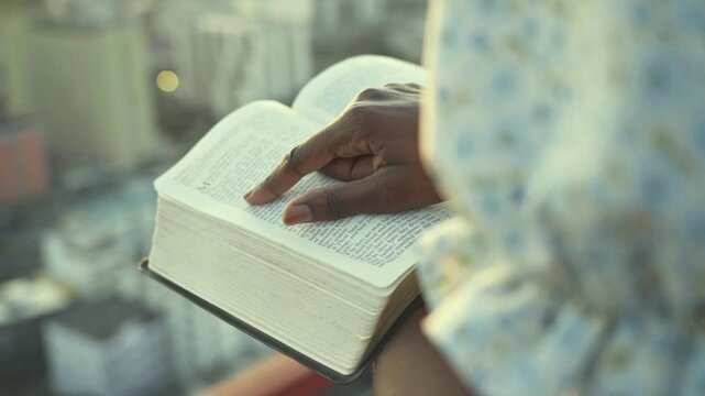 young black Woman afro american Reading Bible at Sunset Outdoors