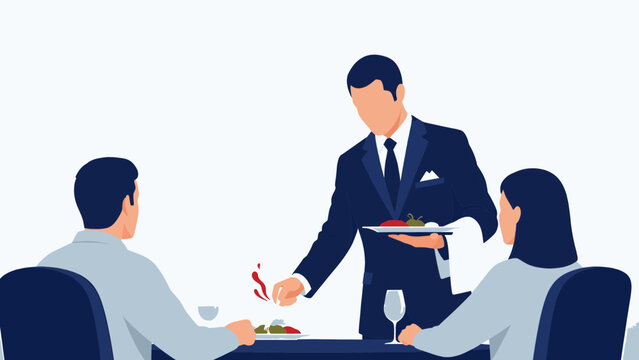 Waiter serving food to couple at restaurant table