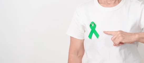 Fotobehang Onderzeeër Elderly with Green Ribbon for concept of March world Bipolar disorder day, Cerebral Palsy Awareness month, kidney disease Cancer and Traumatic Brain Injury, TBI. Healthcare and world cancer day  © Jo Panuwat D