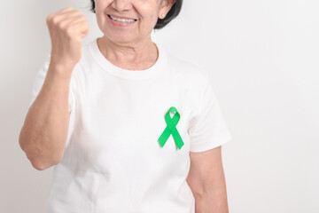 Elderly with Green Ribbon for concept of March world Bipolar disorder day, Cerebral Palsy Awareness...