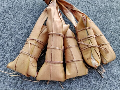 Lepet is a traditional Indonesian snack from Java and Sunda, made of glutinous rice mixed with grated coconut and beans, wrapped in young coconut leaves, then boiled to create a savory, chewy taste