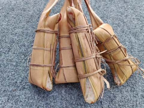 Lepet is a traditional Indonesian snack from Java and Sunda, made of glutinous rice mixed with grated coconut and beans, wrapped in young coconut leaves, then boiled to create a savory, chewy taste