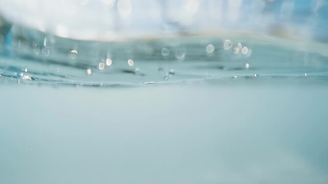 Underwater scene with ripples and bubbles, a serene aquatic landscape, captured in a close-up video