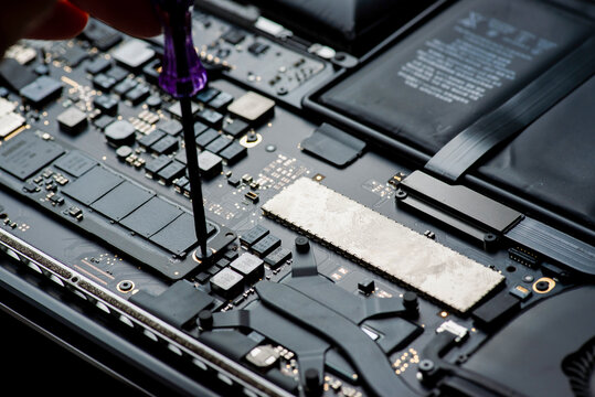 close up of Technician repairing electronic circuit board, repairing deteriorated ssd , upgrade and technology.