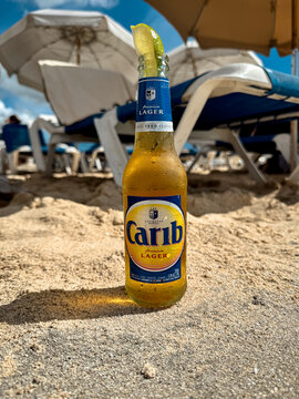 Maho Beach, Sint Maarten - January 1, 2026: Bottles of Carib Beer along the shore of Maho beach in St. Maarten, a famous destination for sunbathing, swimming, and plane spotting.
