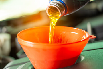 Refueling and pouring oil quality into the engine motor car Transmission and Maintenance Gear...
