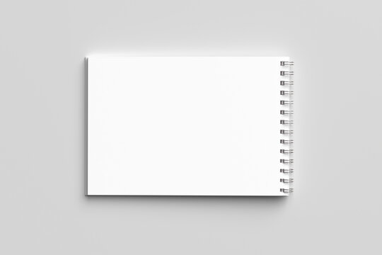 Top view Blank realistic spiral bound notepad mockup of a spiral notebook isolated on a minimalist gray background.