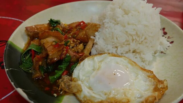 Thai Spicy Basil Stir-Fried Pork with Rice and Fried Egg Khao Pad Krapow