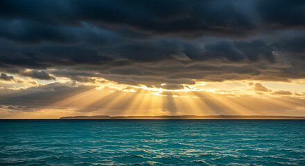 Sunset over ocean with sun rays shining through dark clouds