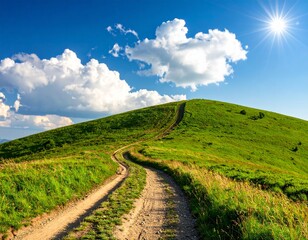 Obraz premium Winding dirt road on a green grassy hill under a bright sunny blue sky with fluffy clouds