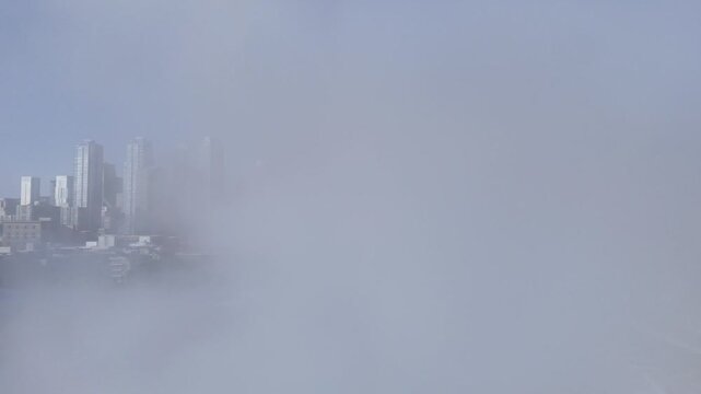 Winter Montreal skyline with skyscrapers rising above steam clouds on a cold frozen morning, Quebec, Canada. g.