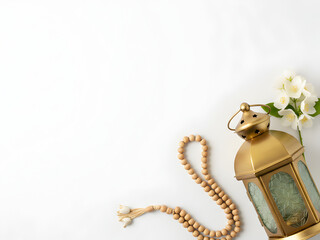 Minimalist Islamic decor on white background featuring lantern and beads