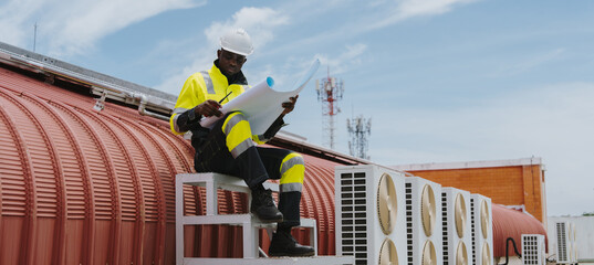 Engineers are checking the air conditioning and cooling system in a commercial building.(PHOTO)