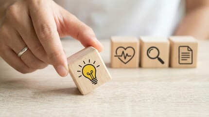Hand holding a wooden block with a light bulb icon representing innovative healthcare solutions and medical research ideas.