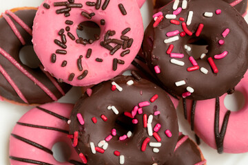 Close-Up of Pink and Chocolate Donuts with Sprinkles