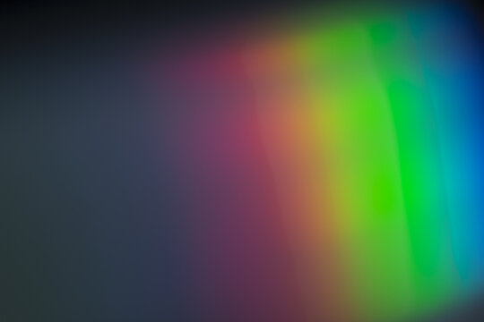 Soft rectangular prism overlay of diffused rainbow spectrum, gentle bands of red, green and blue light forming dreamy abstract gradient background

