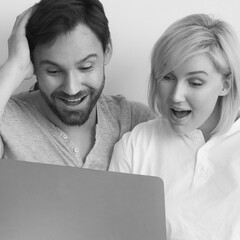 Monochrome image - very happy family, expressive man and woman use laptop at home. Internet sales, rebate deal, discounts, cashback, online shopping, e-commerce, ad concept. B w. Square