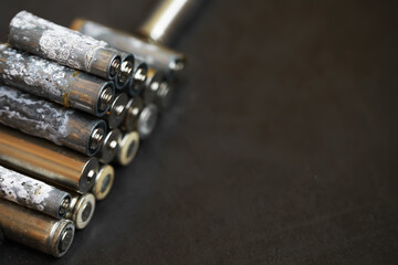 Fototapeta premium Old Corroded Batteries with Oxidation on Dark Background