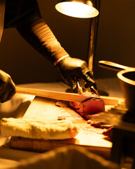 man working on a cooked steak