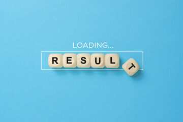 Wooden blocks spelling 'RESULT' with a loading progress bar on a blue background, outcome and success measurement concept