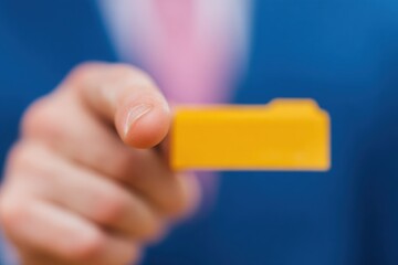 Businessman touching glowing digital file icon for document management system and professional data storage technology in a corporate office setting with copy space