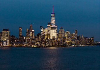 Obraz premium New York night metropolis. NYC skyscrapers at night. NewYork City downtown at night. Lower Manhattan skyline. New York landscape. New York big American City. New York cityscape waterfront.