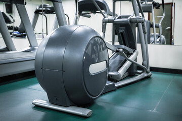 Ellipsoid. Equipment in gym ready for workout in during daytime. Fitness.