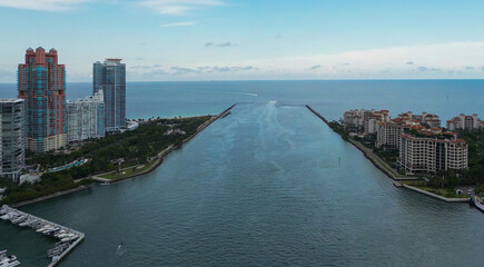 Aerial view of Miami waterfront city skyline. Modern Miami Beach skyline with marina and yachts. Waterfront real estate in Miami Florida. Drone view of coastal Miami city with boats and harbor.