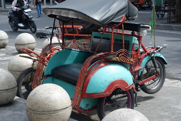 Vintage Pedicab Backseat With Wooden Bench and Red Accents on a Busy City Street