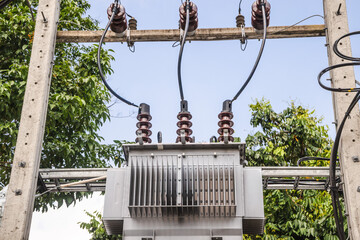 Electrical transformer and power lines on utility pole in tropical Thailand landscape, energy...