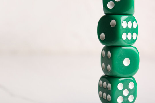 Stack of green dices on light background