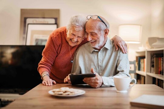 Elderly couple enjoying technology and spending time together.