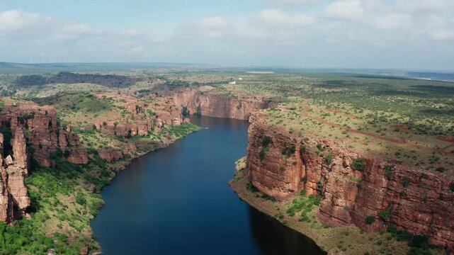 Aerial panorama of Gandikota's dramatic canyon, known as India's Grand Canyon, featuring Pennar River winding between towering red rock cliffs and green plateau landscapes.