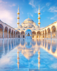 Fototapeta premium Vertical Symmetrical Ottoman Mosque Courtyard with Reflective Marble Floor and Minarets at Sunrise