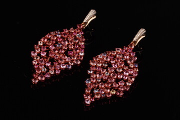 Elegant leaf-shaped dangle earrings featuring soft pink gemstones in a graceful, nature-inspired design. This refined jewelry piece combines organic form with modern elegance, making it ideal for fash