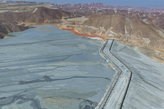 View of a mining tailings dam dike in the process of material accumulation on slopes