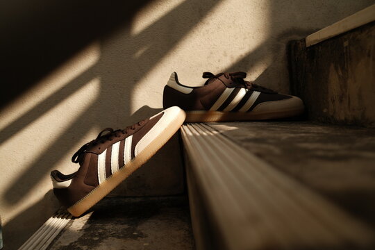 Bangkok,Thailand - January 1,2026 : Adidas Originals Samba brown color unboxing, new adidas samba classic og shoes on stairs cement in Bangkok, Thailand.