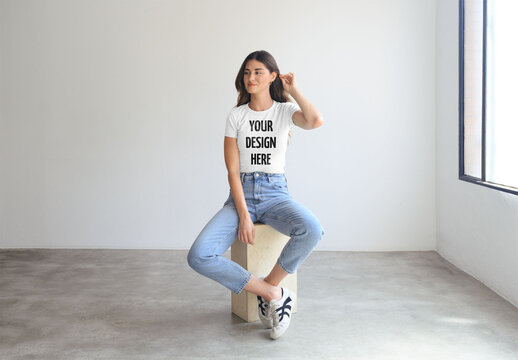 Mockup Of Woman Wearing Customized T-Shirt Sitting In Studio