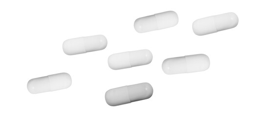a dispersed arrangement of seven white gelatin capsules on a dark background, showcasing their smooth, pharmaceutical form and common use in medicine and supplements.