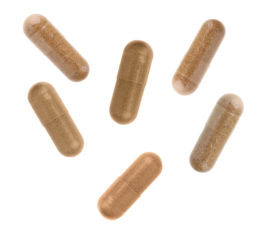 scattered set of six natural herbal supplement capsules, some translucent, some opaque, detailed texture visible against a dark studio background, conveying health and wellness.